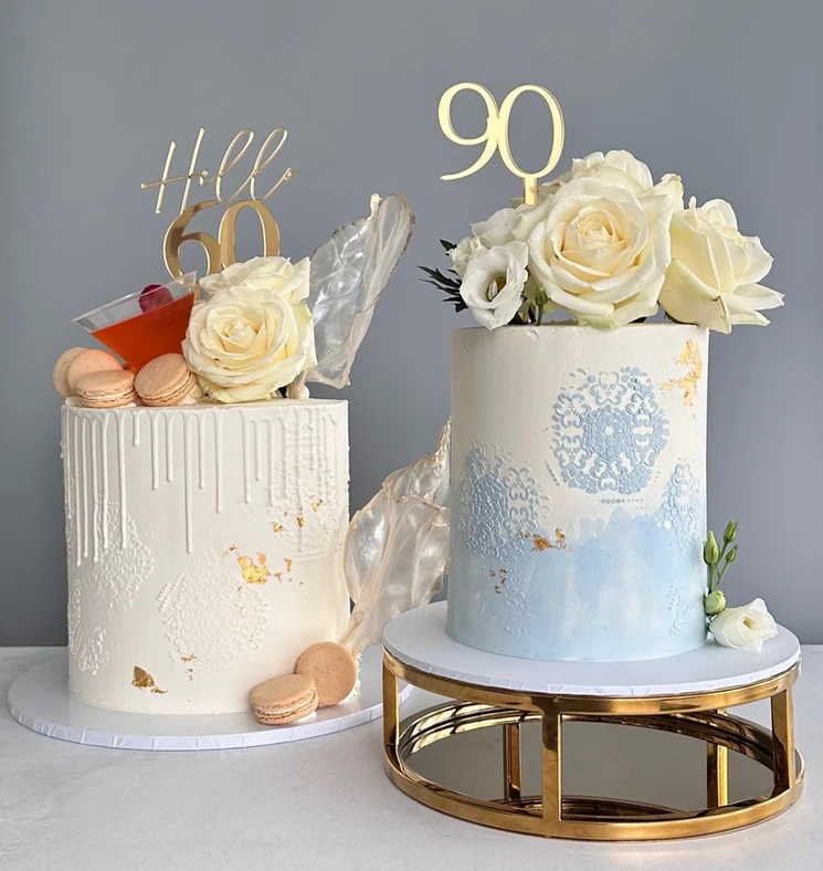 Two birthday cakes with floral toppers