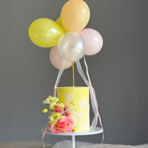 Yellow birthday cake with balloons and flowers Perthshire
