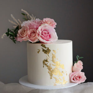 cream and gold birthday cake with fresh flowers Perthshire